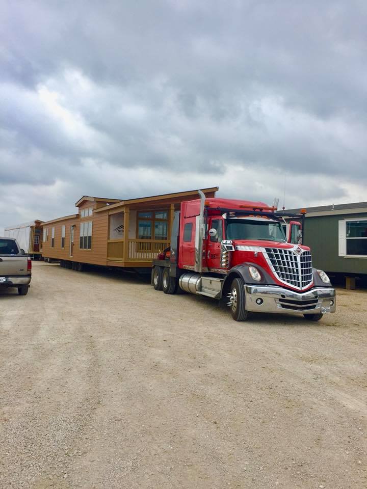 TRANSPORT TRUCK MOVING A MANUFACTURED HOME